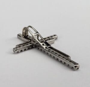 Silver cross-shaped belt buckle.
