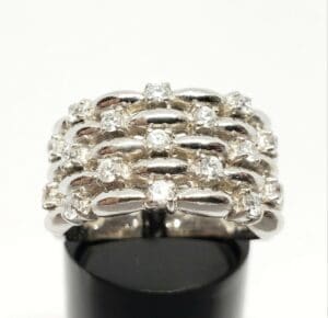 Silver ring with multiple diamond rows.