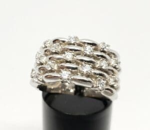 Silver ring with diamond accents on display.