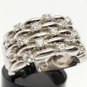 Silver ring with multiple rows of diamonds.