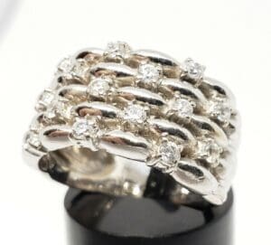 Silver ring with multiple rows of diamonds.