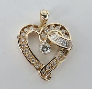 Gold heart pendant with sparkling diamonds.