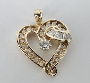 Gold heart pendant with sparkling diamonds.