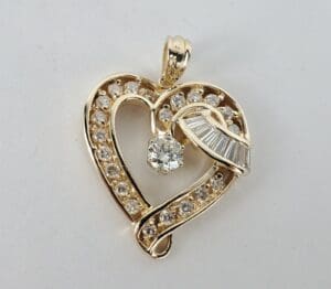 Gold heart-shaped pendant with diamonds.
