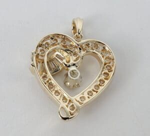 Heart-shaped pendant with embedded gemstones.