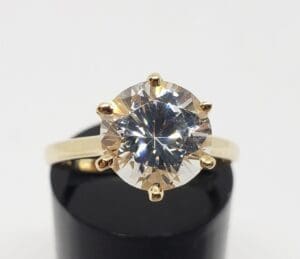 Gold ring with large round diamond solitaire.