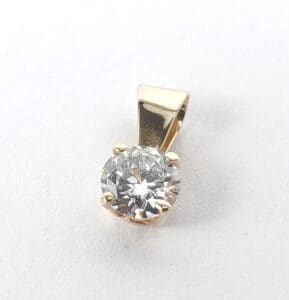 Gold pendant with a round diamond.