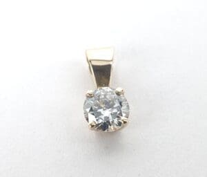 Gold pendant with a round diamond.
