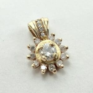 Gold pendant with sparkling diamond accents.