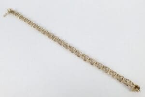 Gold chain bracelet on white background.