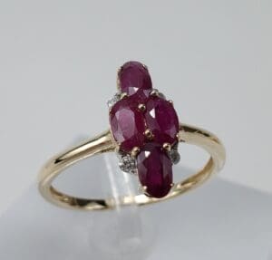 Gold ring with oval red gemstones.