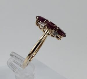 Gold ring with red and white stones.