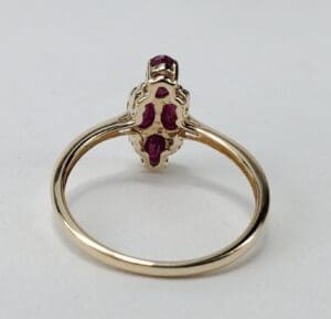 Gold ring with red gemstones, rear view.