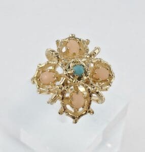 Gold ring with pink and blue stones.