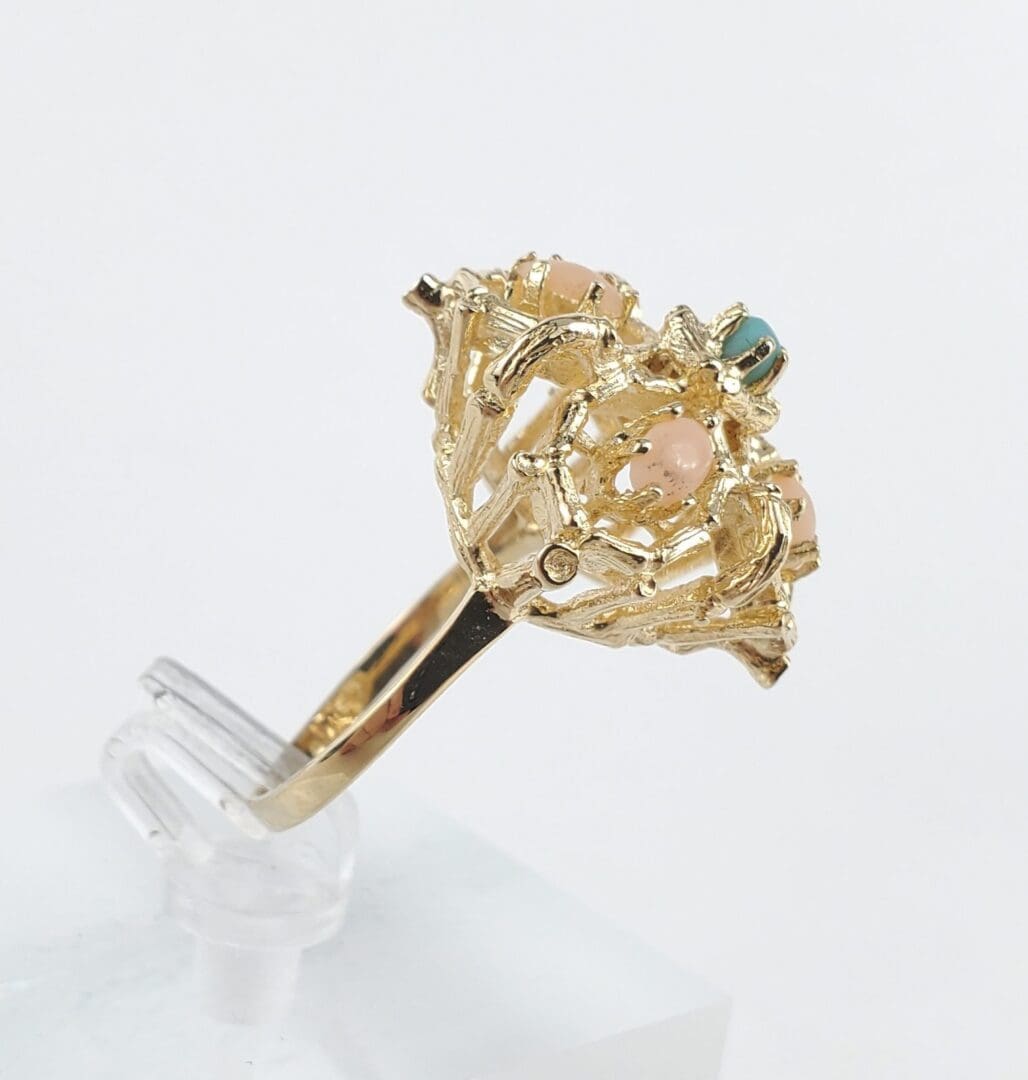 Gold ring with colorful gemstone accents.