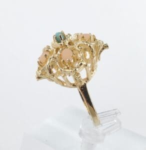 Gold ring with colorful gemstone accents.