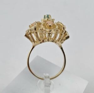 Gold ring with colorful gemstone setting.