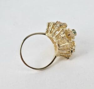 Gold ring with intricate decorative setting.