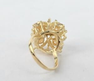 Gold ring with intricate design underside.