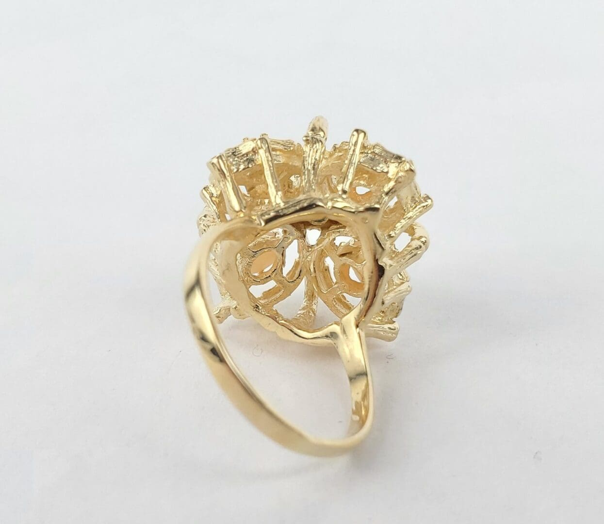 Gold ring with intricate design underside.