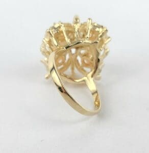 Gold ring with intricate design, rear view.