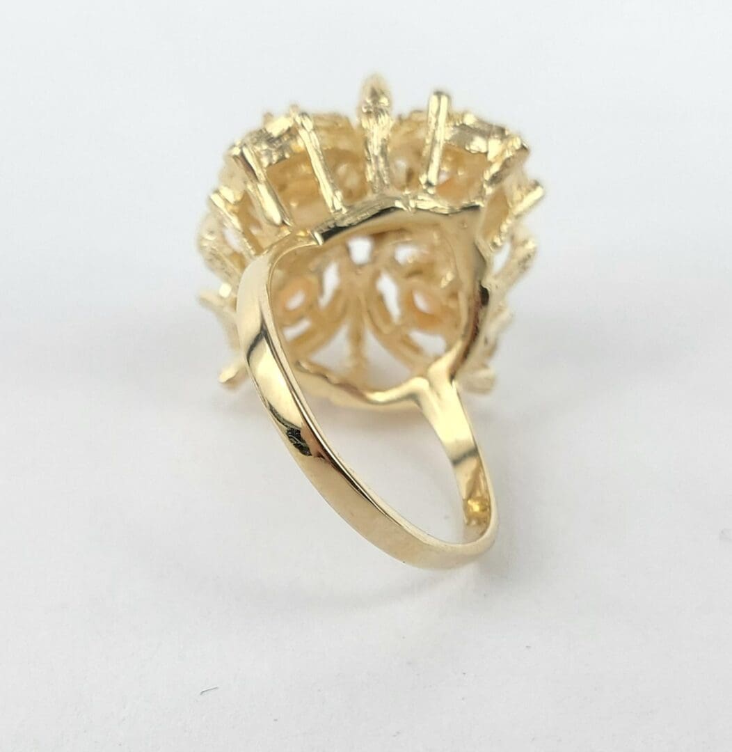 Gold ring with intricate design, rear view.