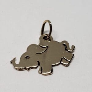 Silver elephant-shaped pendant on white background.
