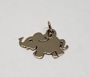 Gold elephant-shaped pendant on white background.