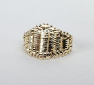 Gold woven-design ring on white background.