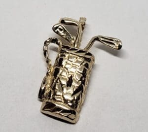 Gold golf bag brooch with clubs.
