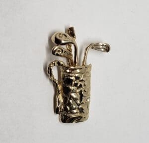 Gold golf bag and clubs brooch.