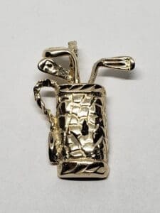 Gold golf bag and clubs pin.