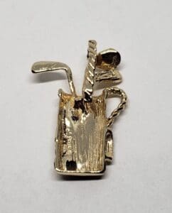 Gold golf bag brooch with clubs.