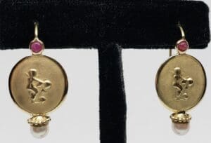 Gold earrings with pink gemstone accents.