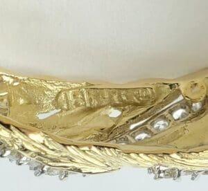 Gold ring with intricate detailing and stones.