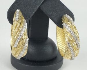 Gold and diamond textured hoop earrings.