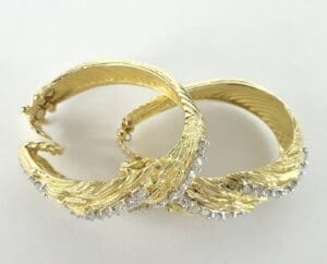 Gold hoop earrings with diamond accents.