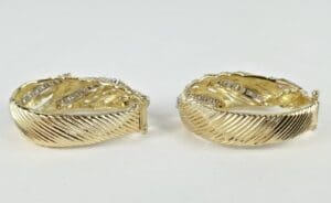 Gold textured hoop earrings with diamonds.