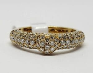 Gold ring with heart-shaped diamond cluster.