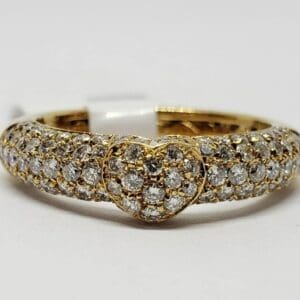 Gold ring with heart-shaped diamond cluster.