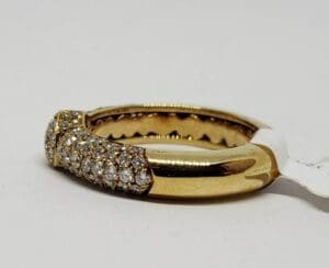 Gold ring with diamond accents on display.