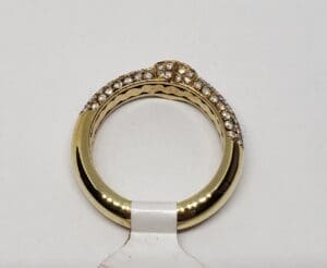 Gold ring with diamond accents on display.
