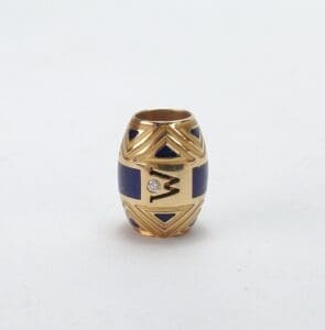 Gold and blue decorative bead with diamond.