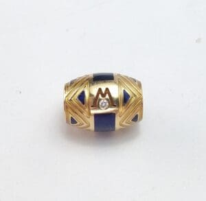 Gold bead with blue accents and diamond.