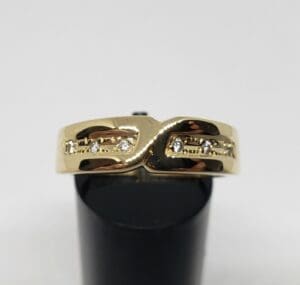 Gold ring with diamond accents on display.