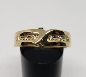 Gold ring with small embedded diamonds.
