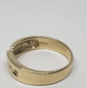 Gold ring with "750" marking inside band.