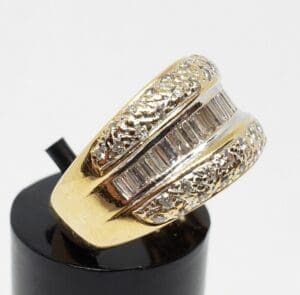 Gold ring with diamond accents on display.