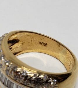 Gold ring with diamond accents, "902" inside.