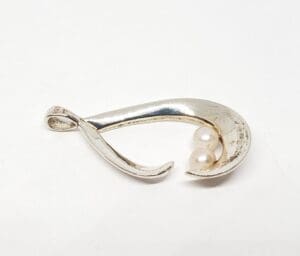 Silver pendant with two small pearls.